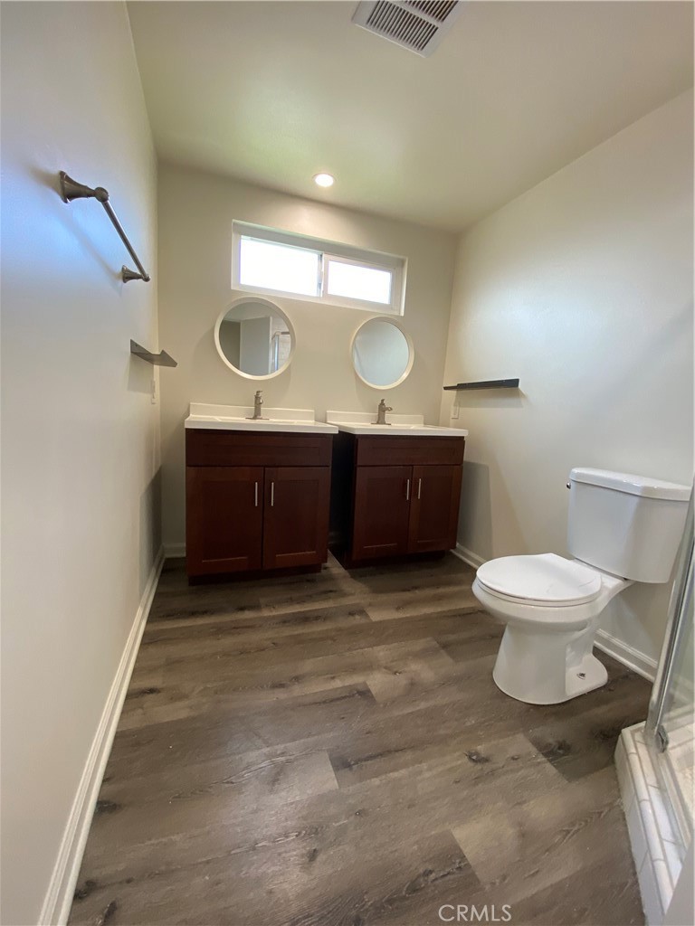 208 South Park View Street, Unit 2 Los Angeles, CA 90057 - Photo 20 of 24 a bathroom with a sink a toilet and a mirror