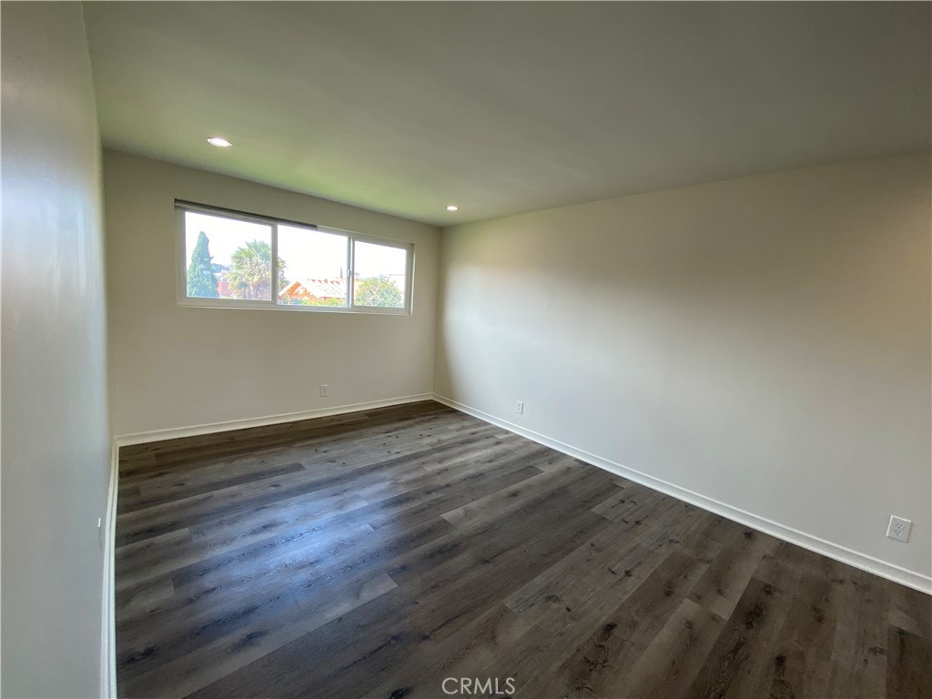 208 South Park View Street, Unit 2 Los Angeles, CA 90057 - Photo 22 of 24 an empty room with wooden floor and windows