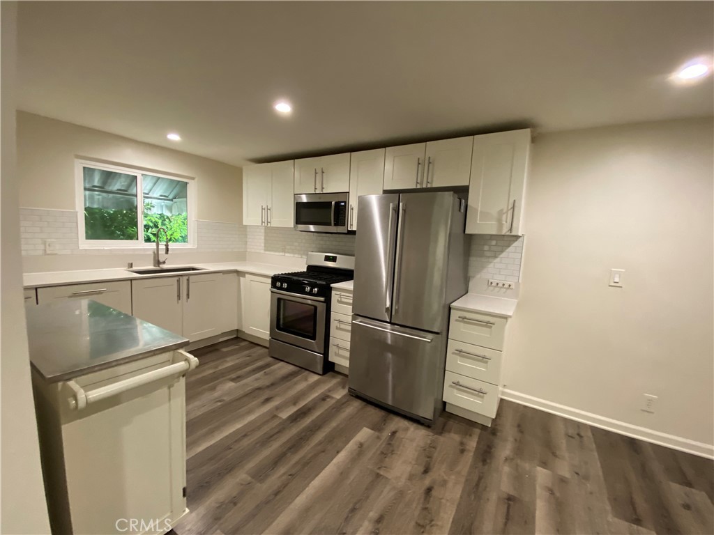 208 South Park View Street, Unit 2 Los Angeles, CA 90057 - Photo 3 of 24 a kitchen with refrigerator cabinets and wooden floor