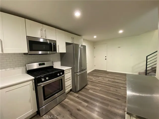 a kitchen with a stove and a microwave