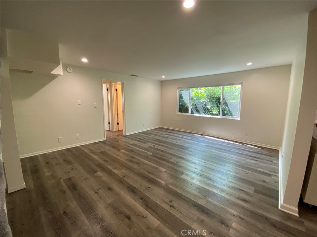 208 South Park View Street, Unit 2 Los Angeles, CA 90057 - Photo 7 of 24 an empty room with wooden floor and windows