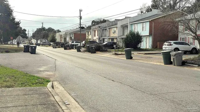 a view of street with houses and trees in the background