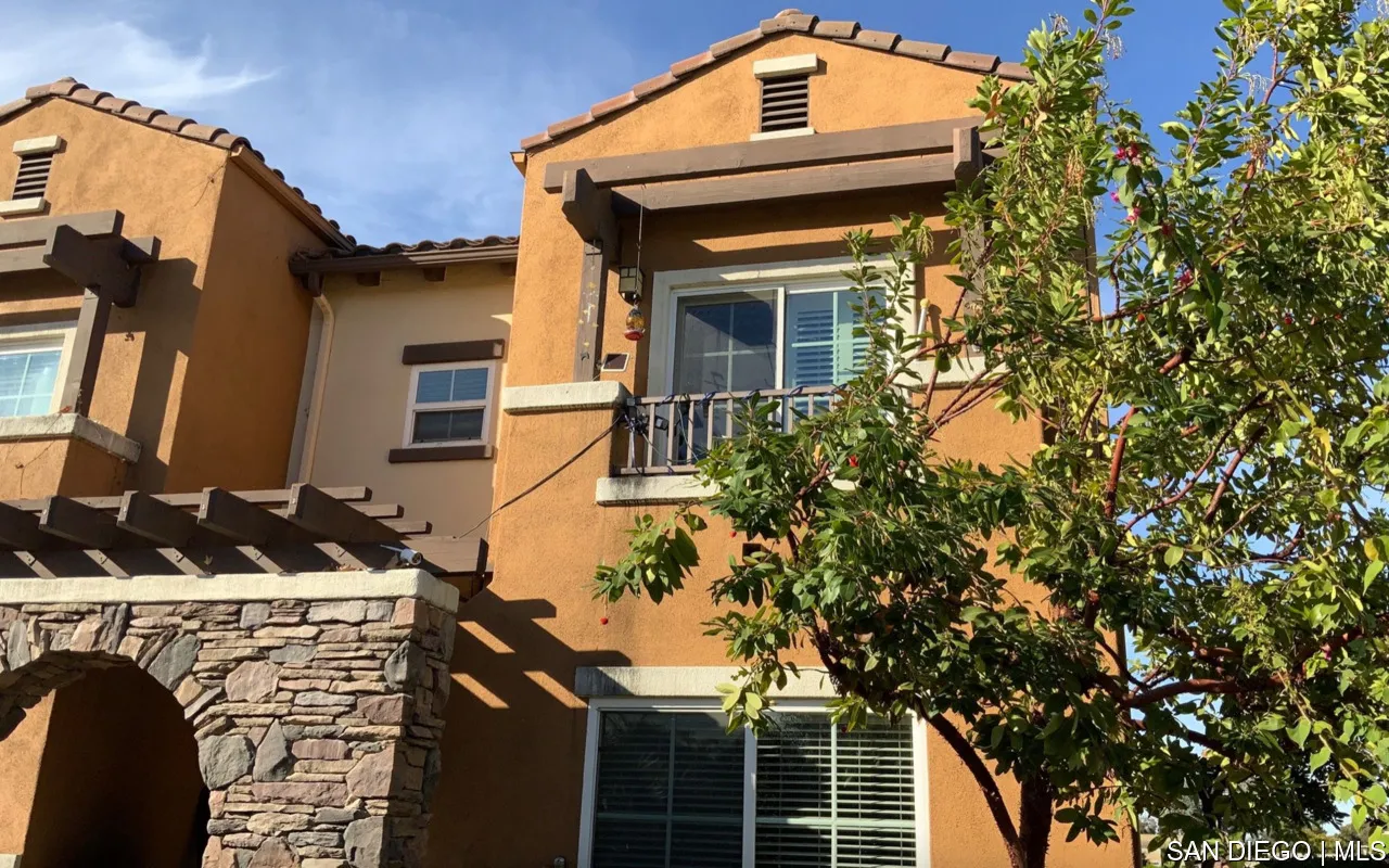 a front view of a house with plants