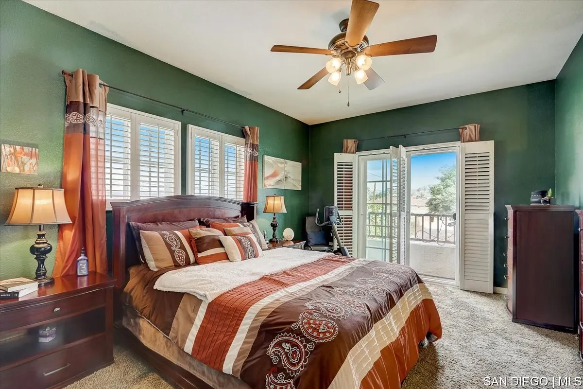 1213 Page Lane Santee, CA 92071 - Photo 11 of 21 a spacious bedroom with a large bed and a chandelier