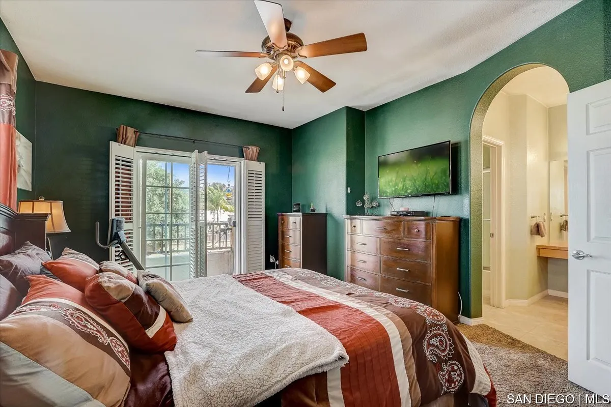 1213 Page Lane Santee, CA 92071 - Photo 12 of 21 a bedroom with a large bed and a flat screen tv