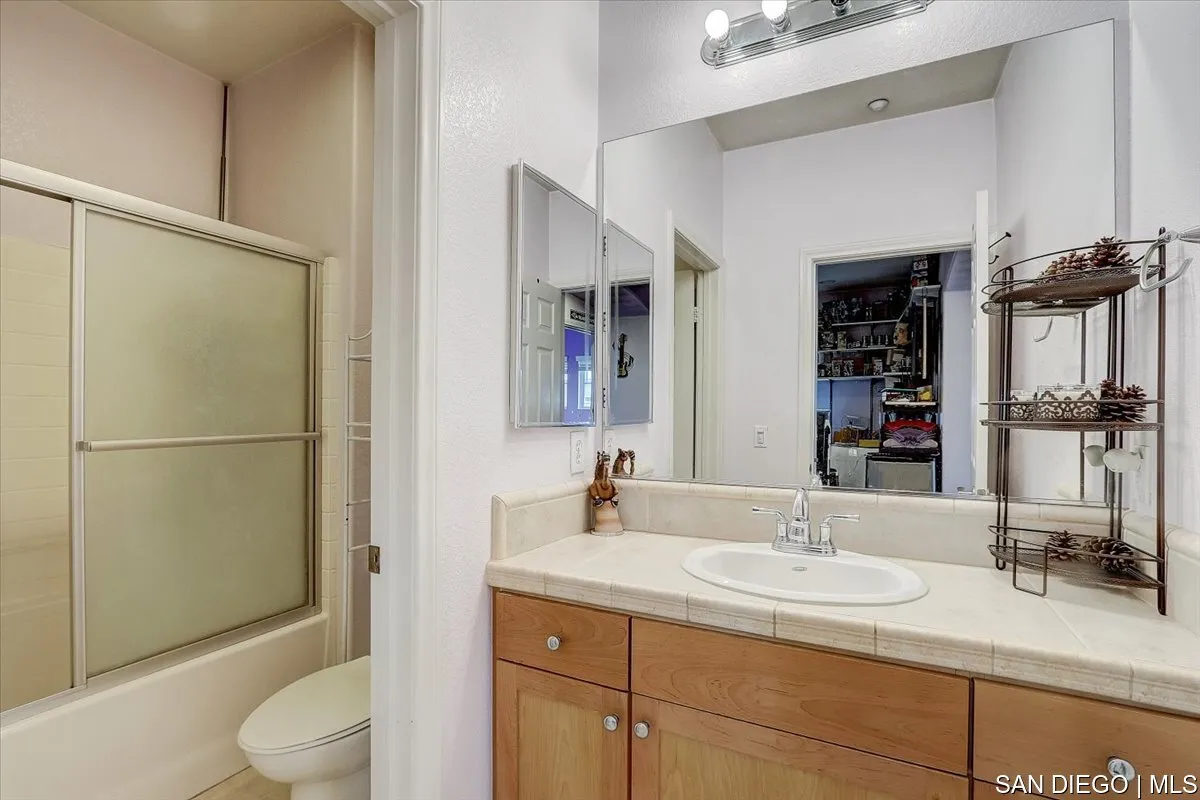 1213 Page Lane Santee, CA 92071 - Photo 16 of 21 a bathroom with a granite countertop sink toilet and shower