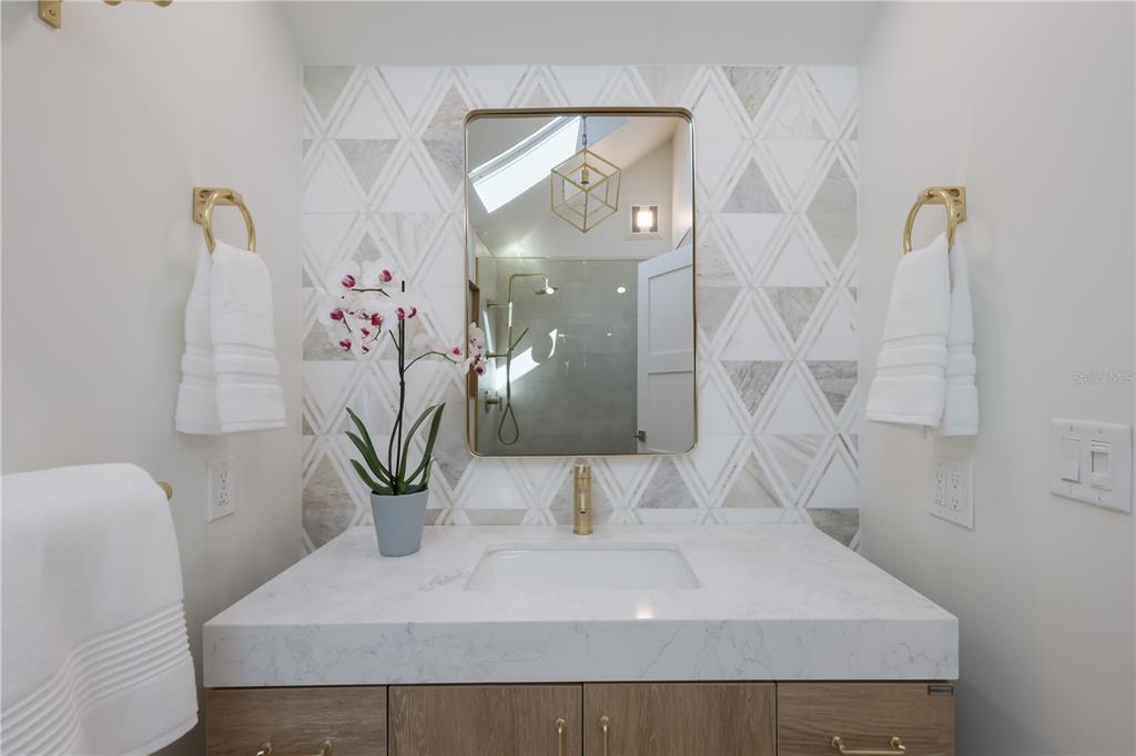 204 Waterway Avenue Boca Grande, FL 33921 - Photo 20 of 49 a bathroom with a sink and mirror