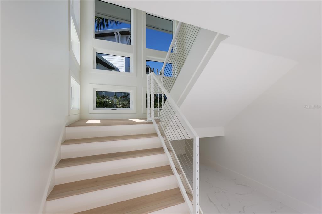 204 Waterway Avenue Boca Grande, FL 33921 - Photo 2 of 49 a view of staircase with a fireplace