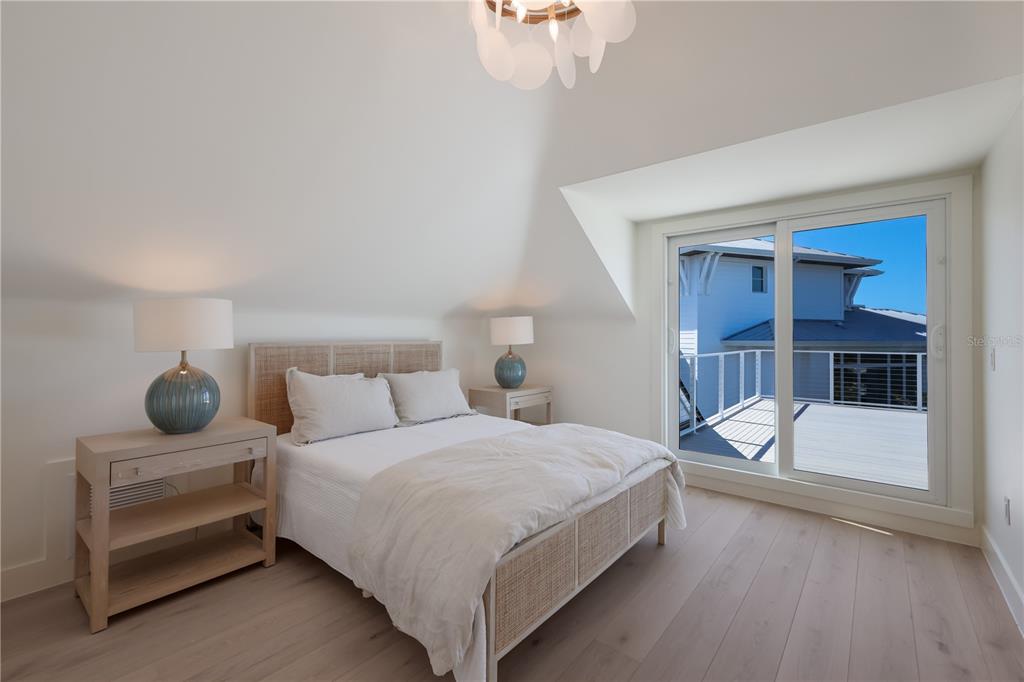 204 Waterway Avenue Boca Grande, FL 33921 - Photo 21 of 49 a bedroom with a bed and a window