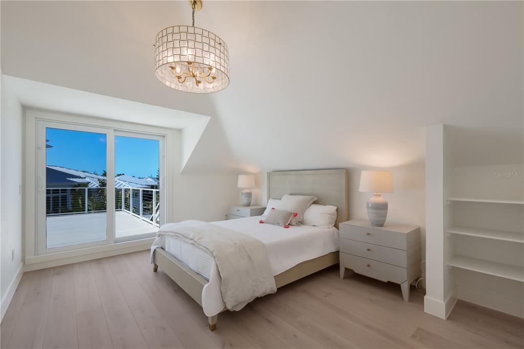 204 Waterway Avenue Boca Grande, FL 33921 - Photo 22 of 49 a bedroom with bed and a window