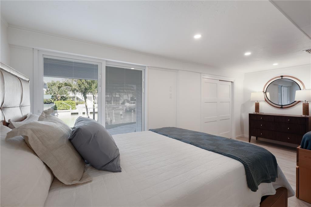 204 Waterway Avenue Boca Grande, FL 33921 - Photo 25 of 49 a bedroom with a bed a dresser and window