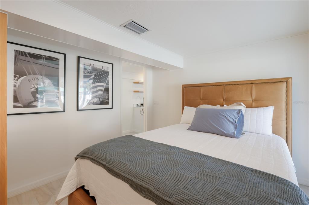204 Waterway Avenue Boca Grande, FL 33921 - Photo 26 of 49 a bedroom with a large bed and a painting on the wall