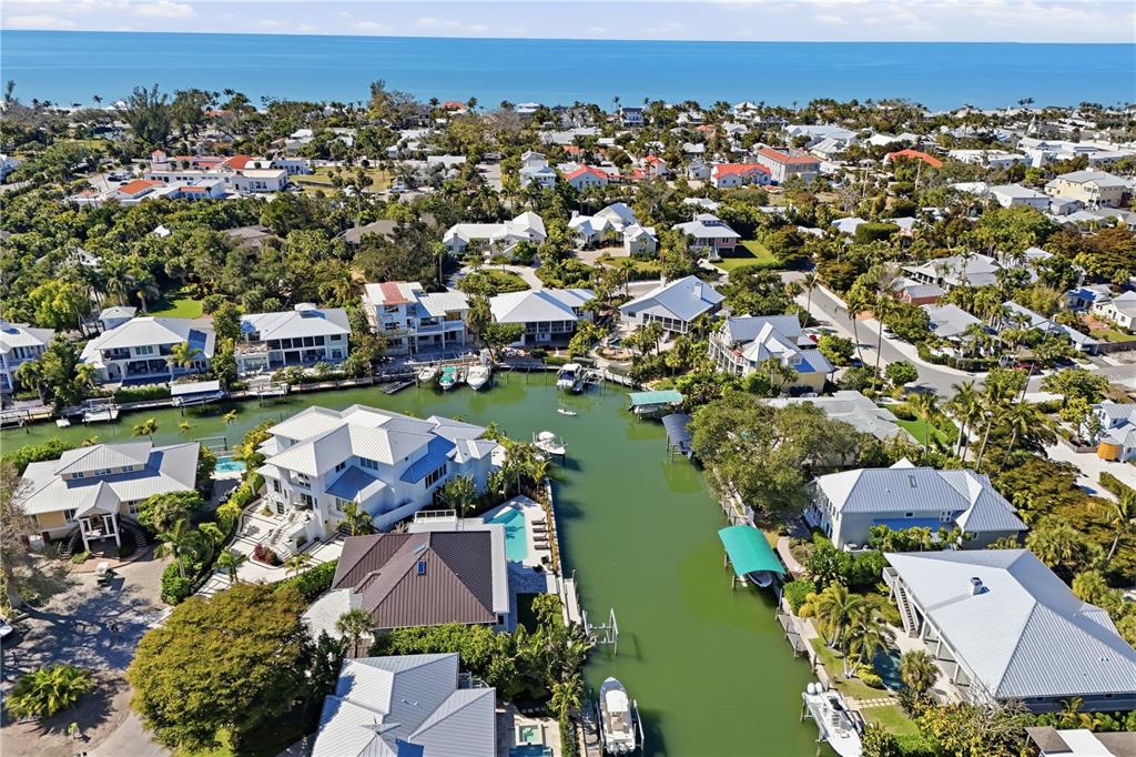 204 Waterway Avenue Boca Grande, FL 33921 - Photo 33 of 49 an aerial view of a city with lots of residential buildings ocean and mountain view in back