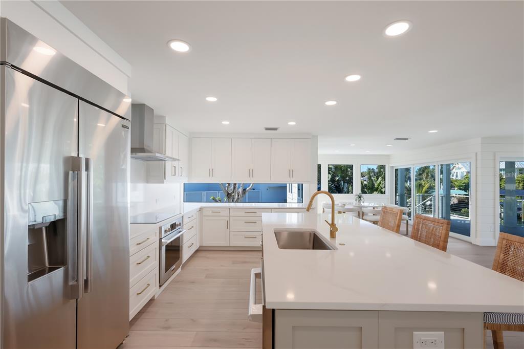 204 Waterway Avenue Boca Grande, FL 33921 - Photo 4 of 49 a kitchen with stainless steel appliances a refrigerator sink and cabinets