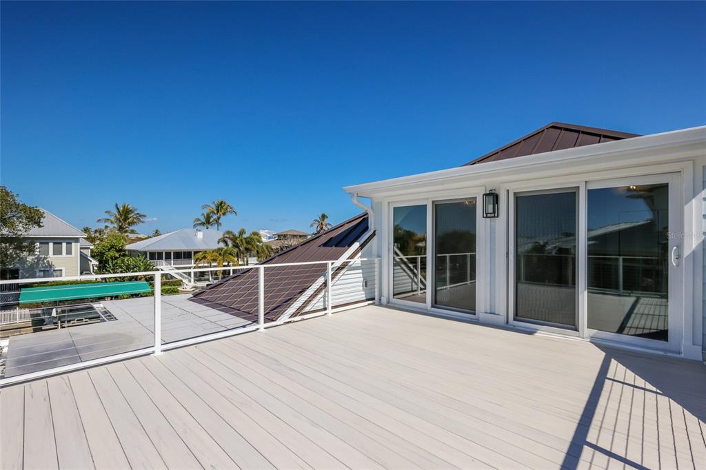 204 Waterway Avenue Boca Grande, FL 33921 - Photo 42 of 49 a view of a roof deck with wooden floor and fence