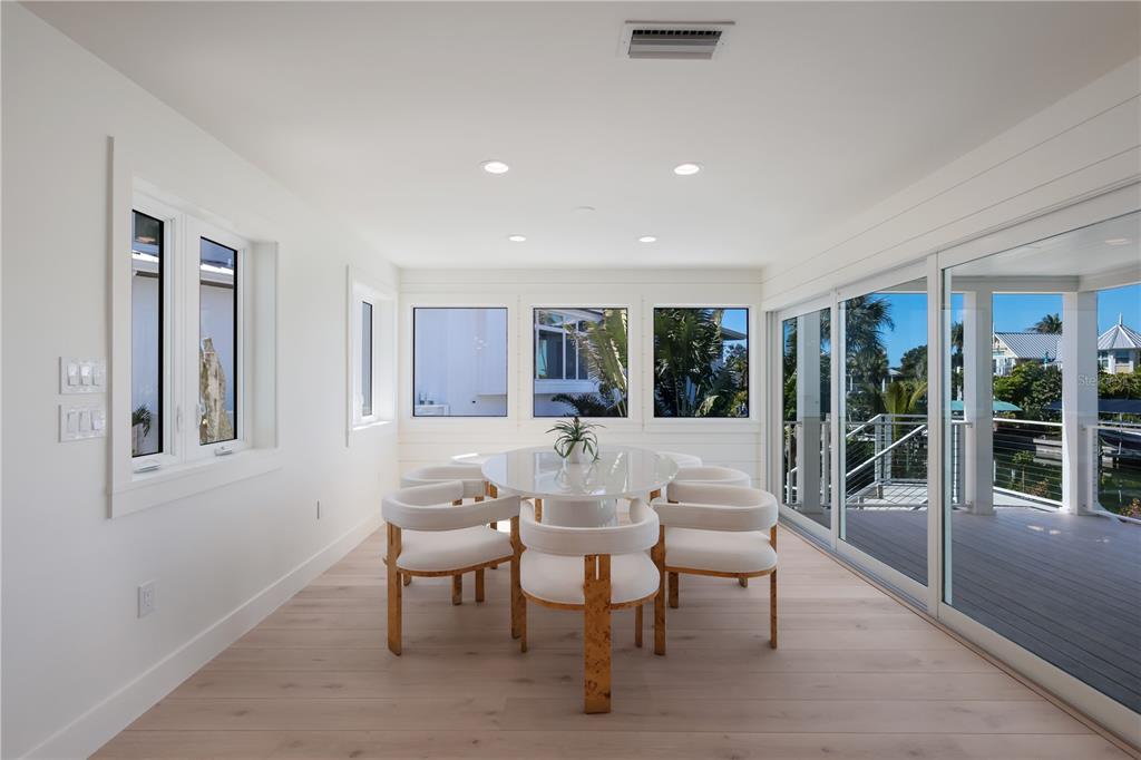204 Waterway Avenue Boca Grande, FL 33921 - Photo 8 of 49 a view of a dining room with furniture wooden floor and chandelier
