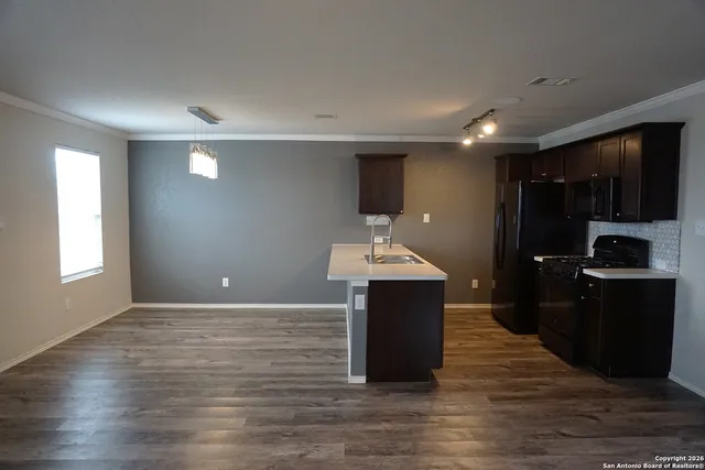 a kitchen with kitchen island sink and center island