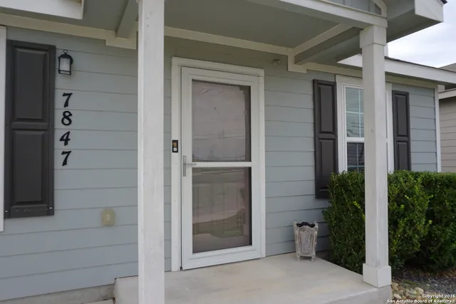 a view of front door and small yard