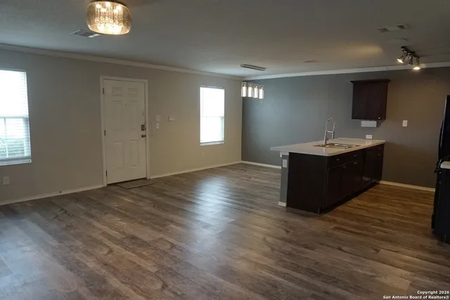 a room with a wooden floor and window