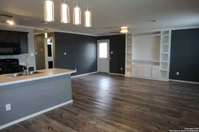 a living room with hard wood floors and a wooden floors