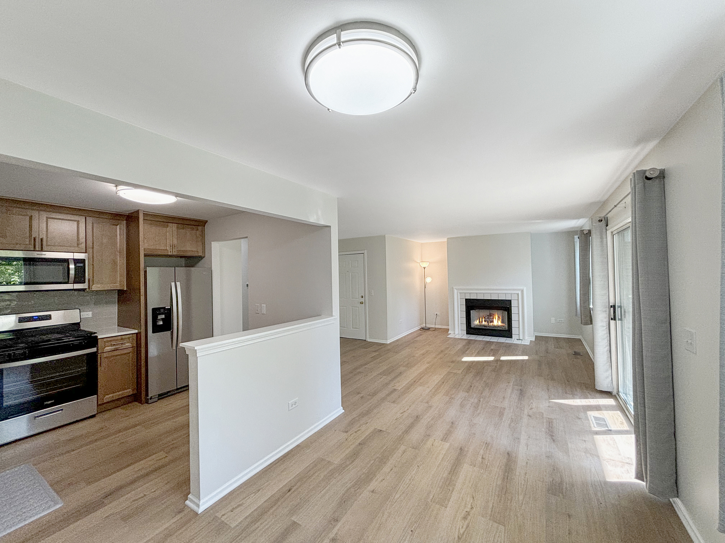 71 Larch Court, Unit B Schaumburg, IL 60193 - Photo 4 of 14 a view of a livingroom with wooden floor and kitchen space