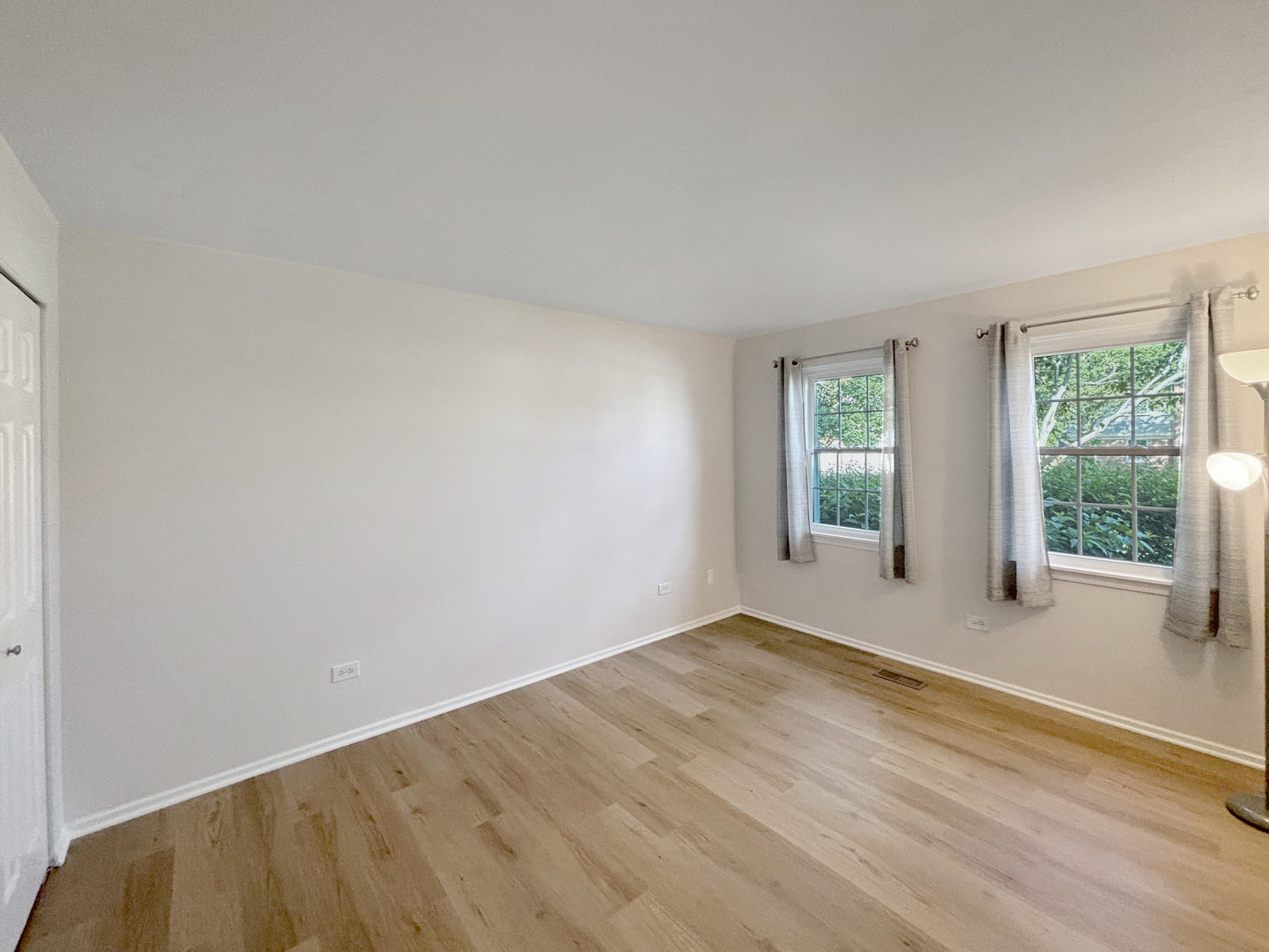71 Larch Court, Unit B Schaumburg, IL 60193 - Photo 8 of 14 a view of an empty room with wooden floor and a window