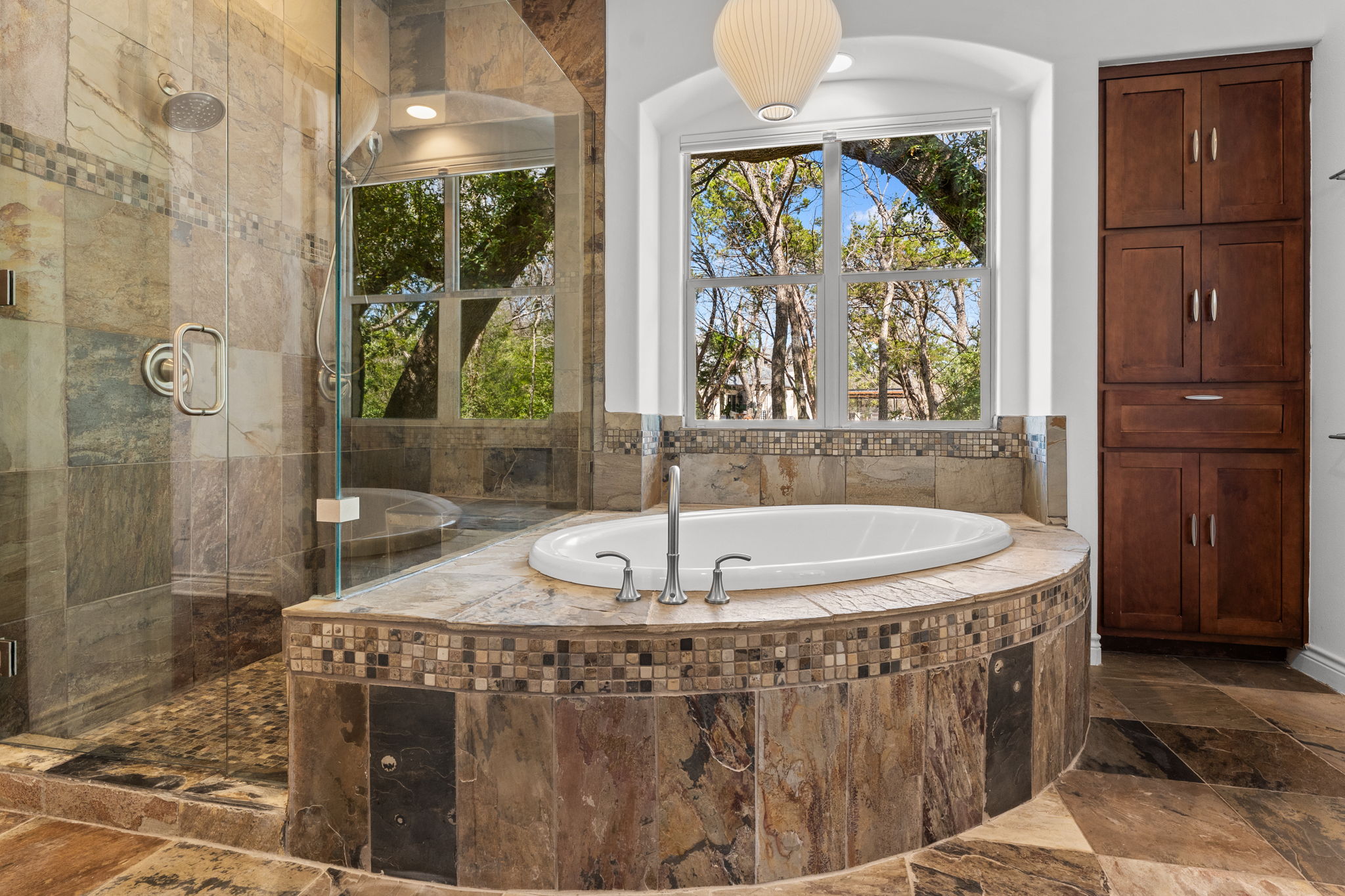 9514 San Lucas Road Austin, TX 78737 - Photo 23 of 38 a bathroom with a granite countertop sink a mirror and a shower