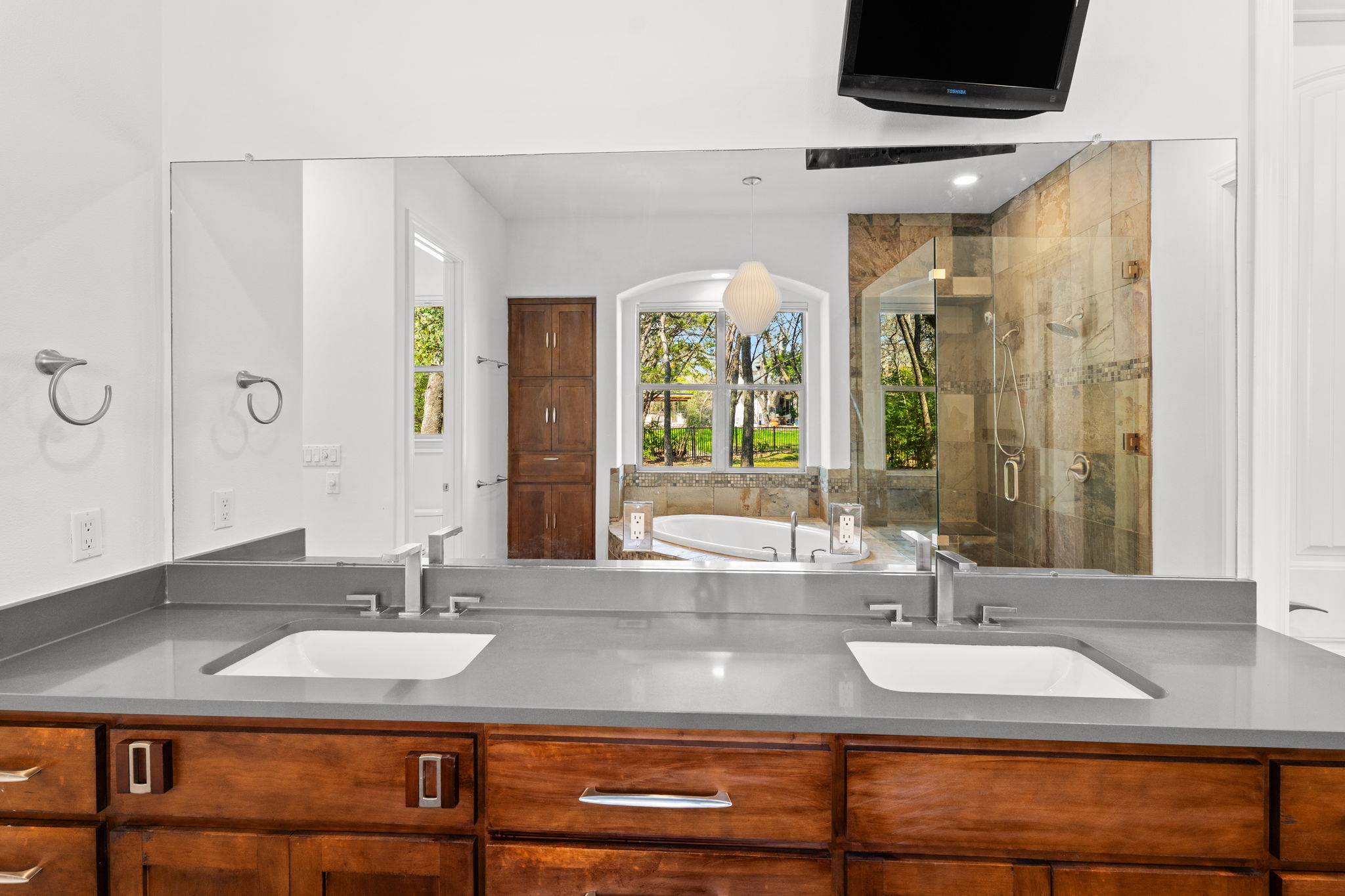 9514 San Lucas Road Austin, TX 78737 - Photo 24 of 38 a bathroom with a granite countertop sink and a mirror