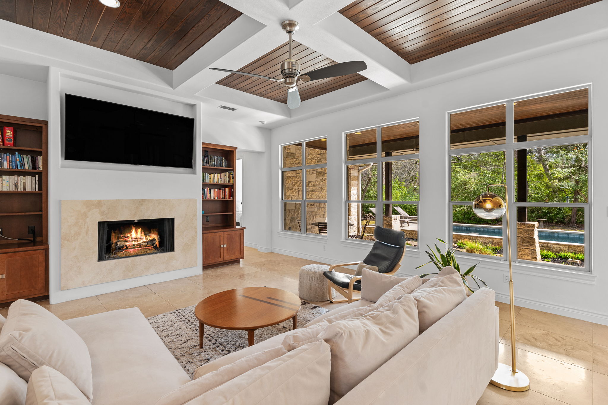 9514 San Lucas Road Austin, TX 78737 - Photo 7 of 38 a living room with furniture a fireplace and a flat screen tv