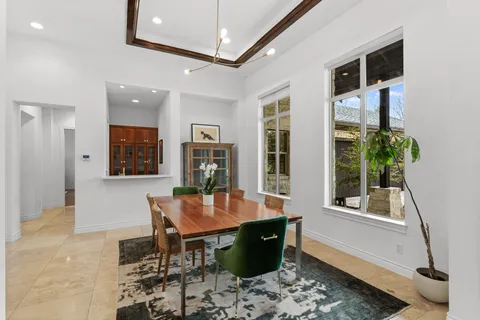 a dining room with furniture and a window