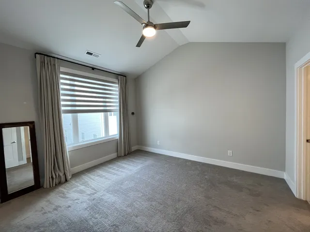 an empty room with a empty space and windows