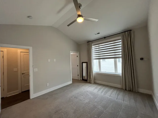 an empty room with windows and closet