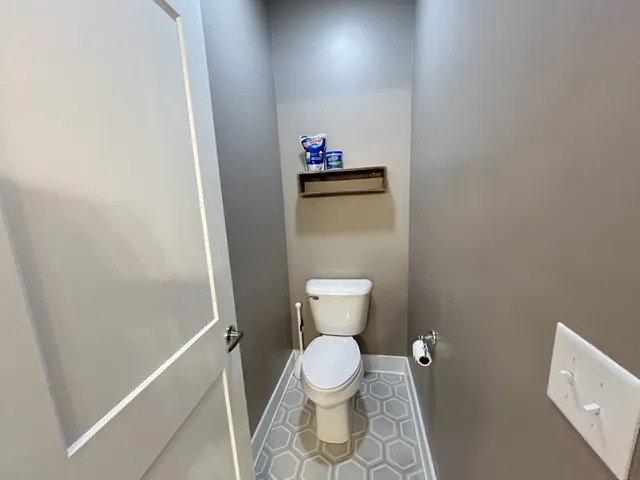 a bathroom with a toilet and a shower