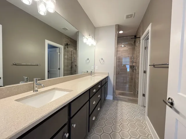a bathroom with a double vanity sink and mirror