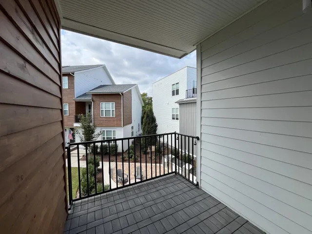 a view of a balcony with wooden floor