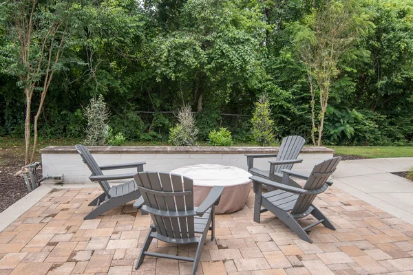 a view of backyard with a table and chairs