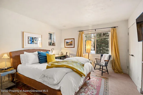 a bed room with a bed and a chair