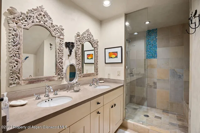 a bathroom with a sink double vanity and a mirror