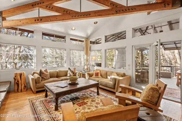a living room with furniture a rug and a large window