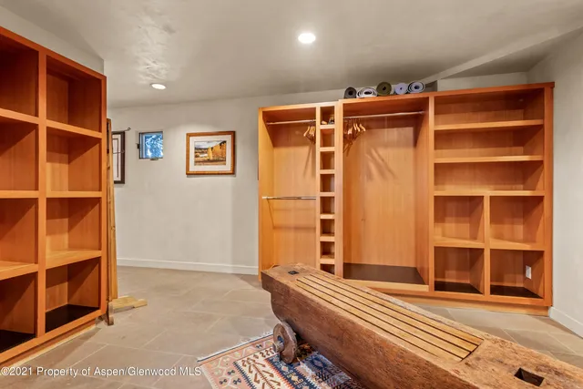 a view of walk in closet with empty racks