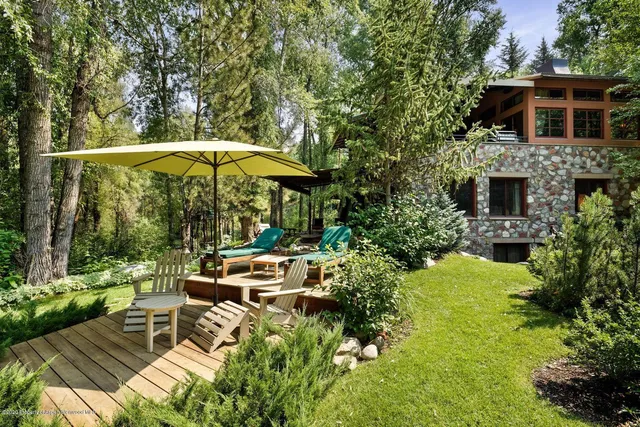 a view of a patio with table and chairs under an umbrella