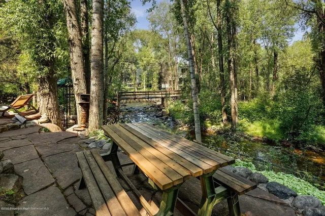 a view of a patio with table and chairs and wooden floor