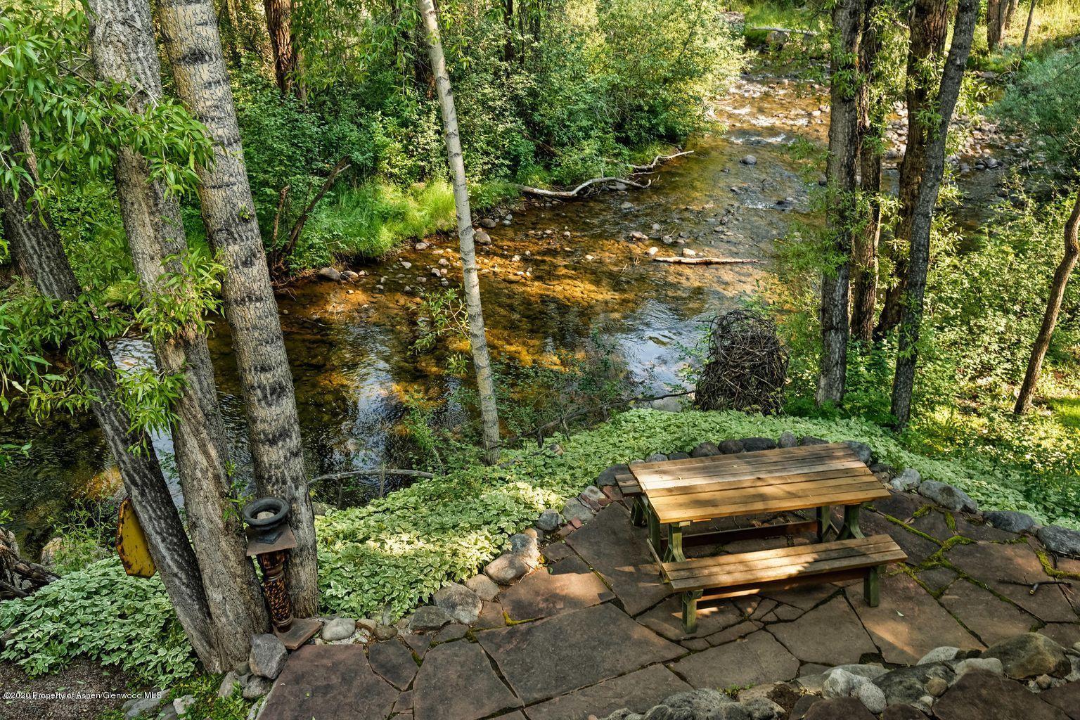 111 Neale Avenue Aspen, CO 81611 - Photo 28 of 30 a backyard of a house with a yard and outdoor seating