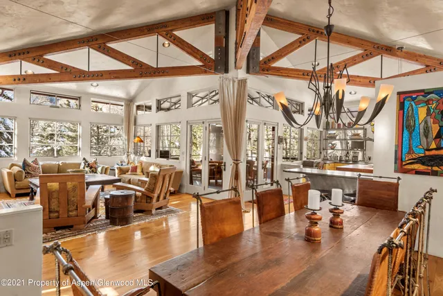 a living room with lots of furniture and a large window