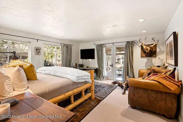 a bedroom with furniture and a flat screen tv