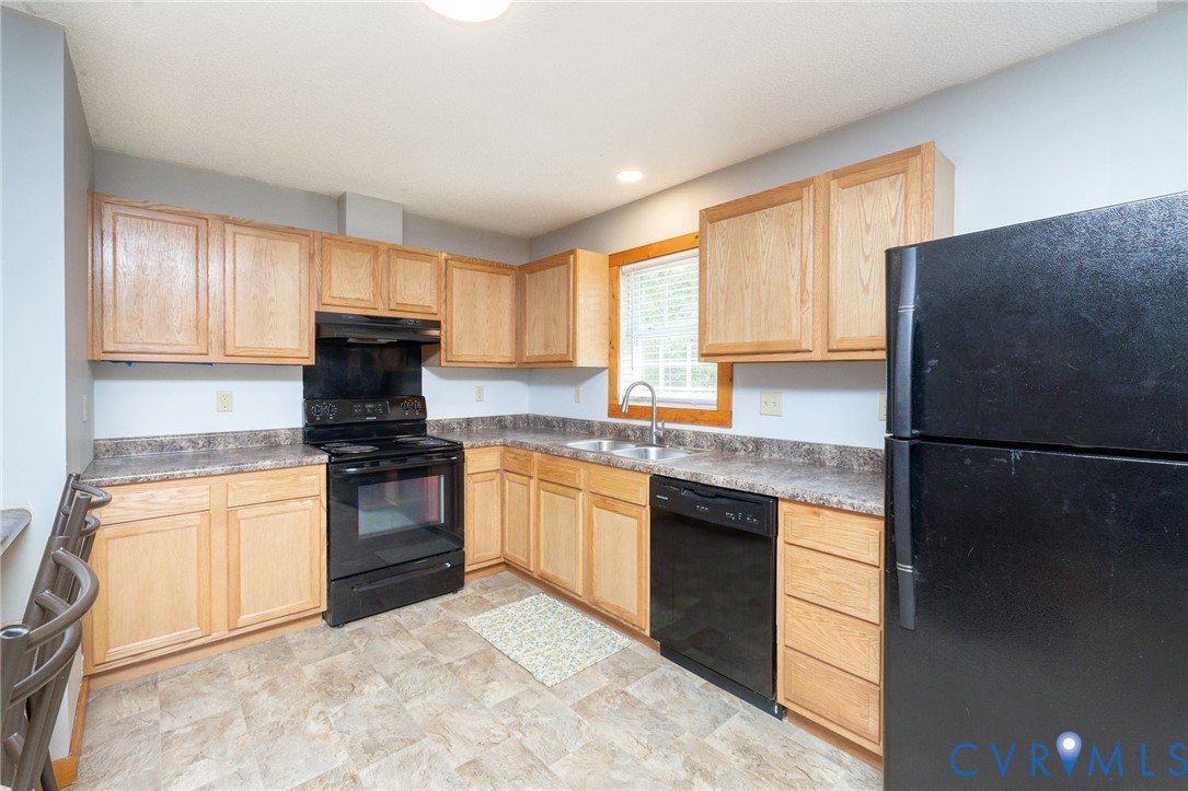 460 Horseshoe Road Jarratt, VA 23867 - Photo 8 of 24 a kitchen with granite countertop a refrigerator stove top oven and sink