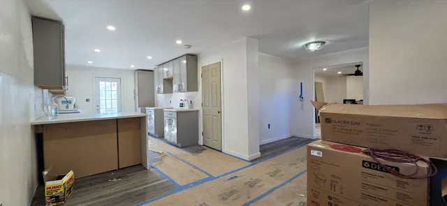a kitchen with stainless steel appliances kitchen island wooden cabinets and granite counter tops