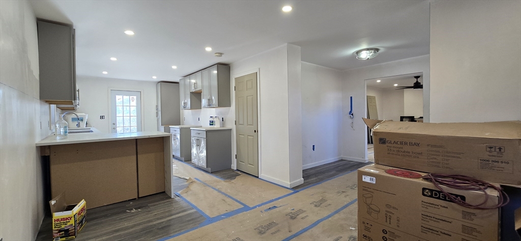 109 Mendon Road Sutton, MA 01590 - Photo 2 of 17 a kitchen with stainless steel appliances kitchen island wooden cabinets and granite counter tops
