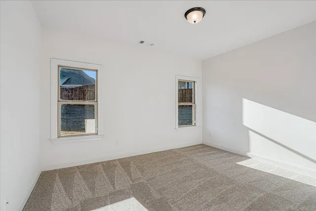 a view of a room with wooden floor and cabinet