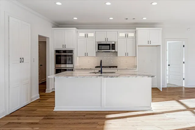 a view of kitchen with wooden floor and electronic appliances